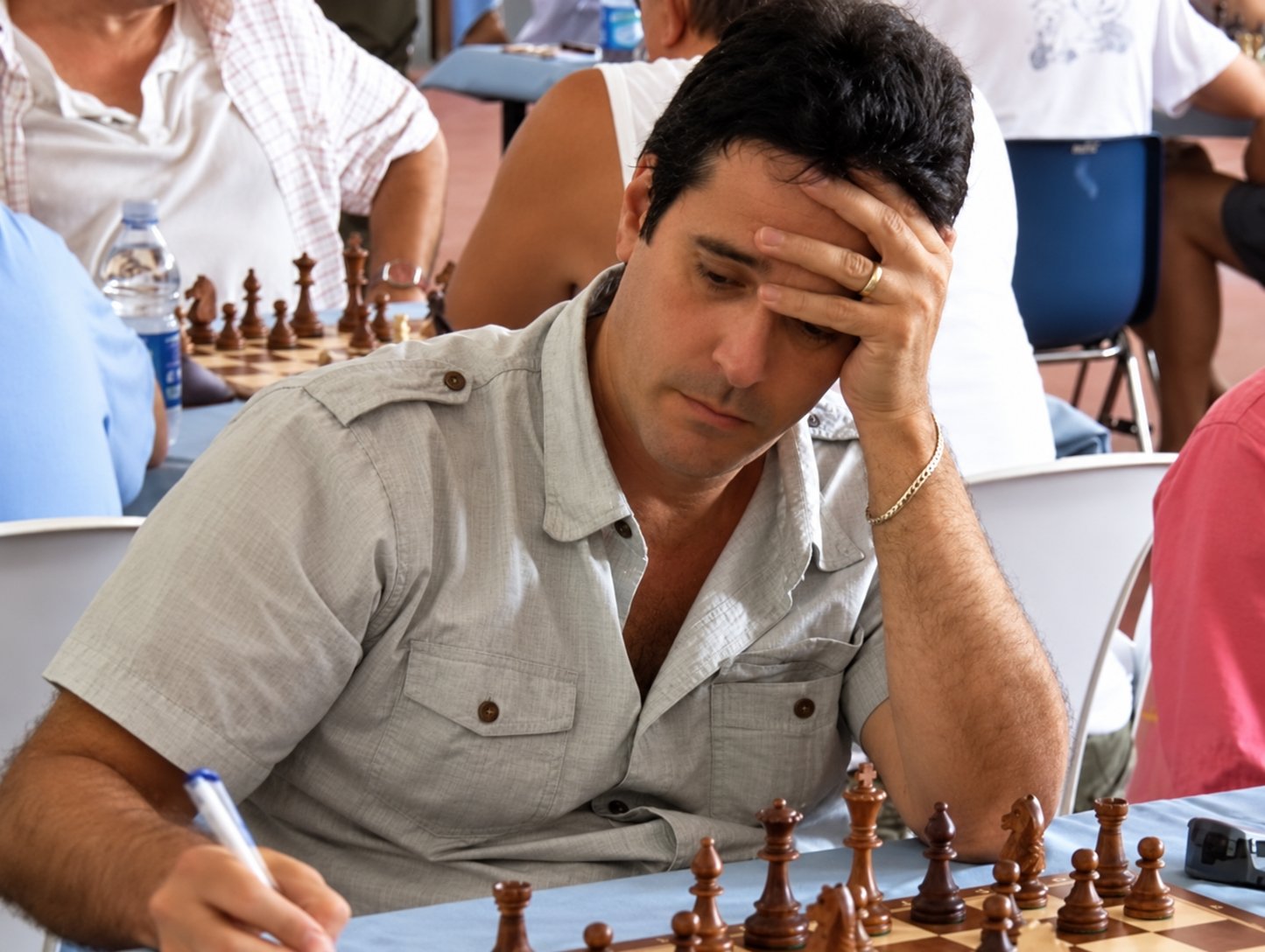 Lexy Ortega concentrating at a chessboard, with one hand on his forehead; editorial restoration of a supplied photograph.